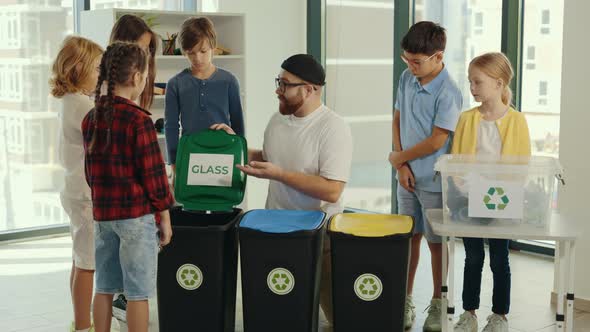 Garbage Sorting Lesson a Young Male Teacher Tells and Explains to Children How and Where to Sort