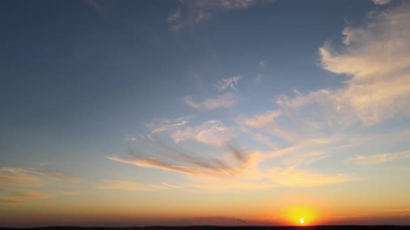 Bright Colorful Sunset Sky with Rays of Setting Sun and Vivid Dark Clouds