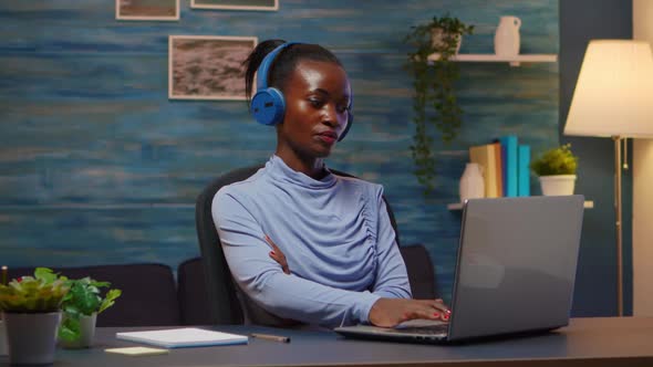 African American with Wireless Headphones Listening Online Courses