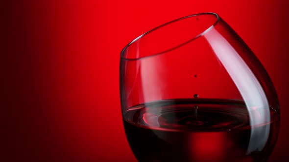 Super Slow Motion Shot of Wine Drop Falling Into Red Wine in Glass at 1000Fps