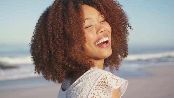 Portrait of African American woman laughing at beach