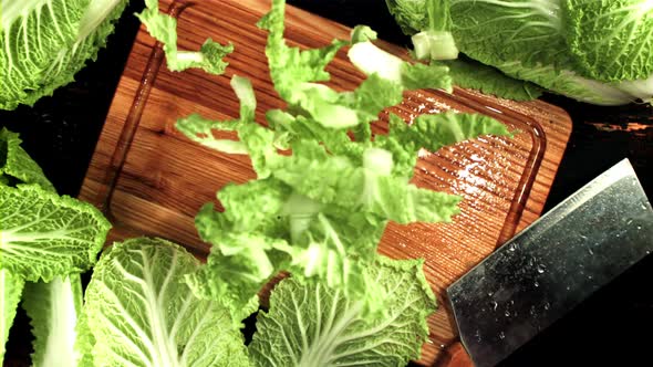 Sliced Beijing Cabbage Falls on a Wooden Cutting Board