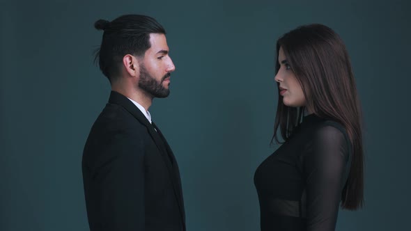 Seductive Man and Sexy Woman Looking Each Other in the Eye Standing Face to Face Experiencing