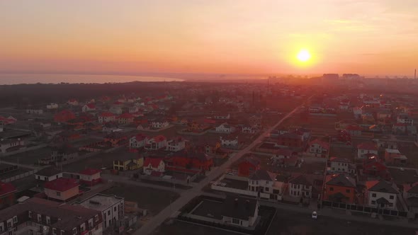 Construction Site in the Middle of the City and Private Houses at Sunset