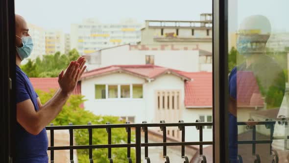 Man in Coronavirus Quarantine Clapping