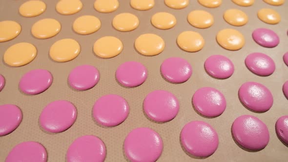 Pastry Chef is Filling Cream Chocolate Macarons with Pastry Bag