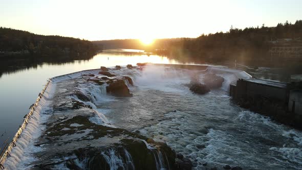 Flying Over Falls with Sun Setting Behind