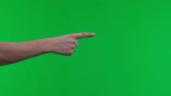 Female Index Finger on a Green Background Points to the Side