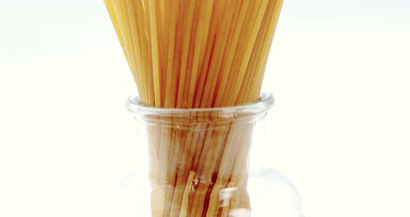Raw spaghetti arranged in container