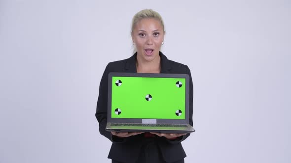 Young Happy Blonde Businesswoman Showing Laptop and Looking Surprised