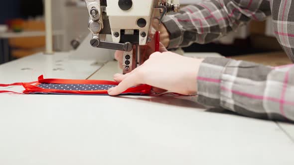 Female Tailor Using Sewing Machine for Making Medical Mask