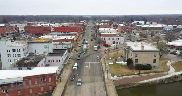 Owosso Michigan downtown skyline with drone videoing forwards.