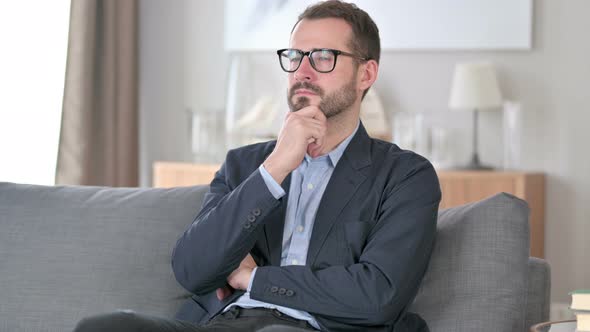 Pensive Young Businessman Thinking at Home 