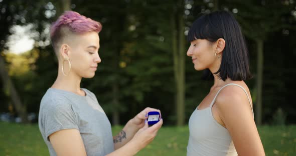 Pretty Lesbian Woman Proposing to Her Girlfriend to Get Married and Smiling