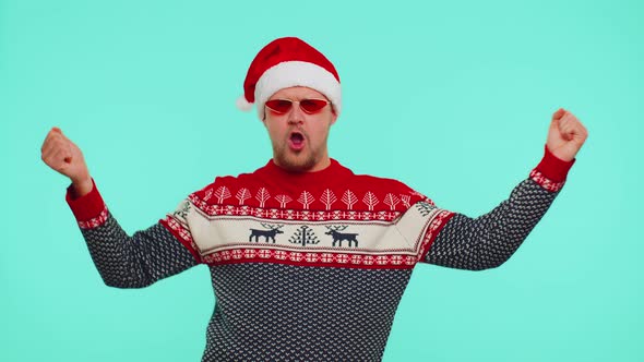 Man in Christmas Sweater Listening Music Via Earphones Dancing Disco Fooling Around Having Fun