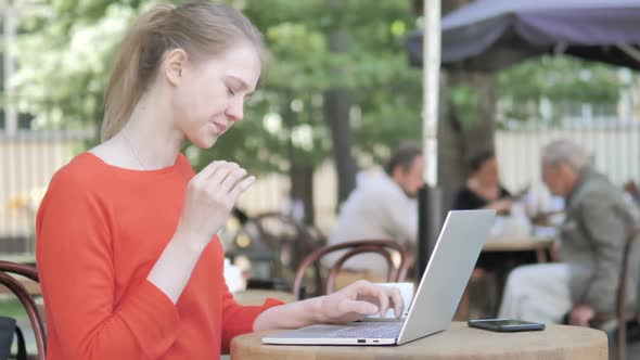 Young Businesswoman with Back Pain Working on Laptop Outdoor