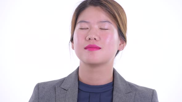 Face of Happy Young Asian Businesswoman Relaxing with Eyes Closed