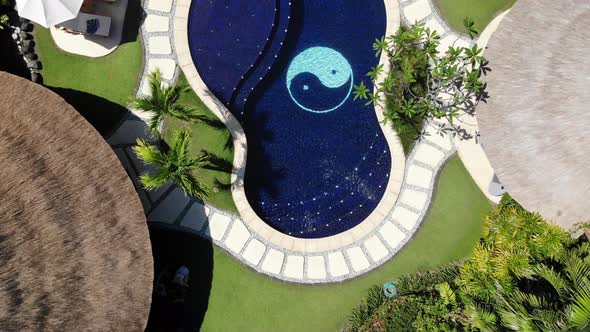 Aerial zoom out directly above Impiana Private Villas resort in Seminyak, Bali