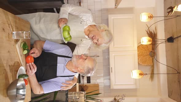 Caucasian Elderly Couple Preparing a Salad Together in the Kitchen