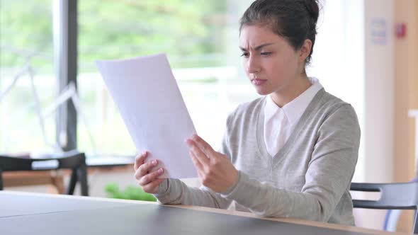 Beautiful Indian Woman Reading Document Having Loss at Work 