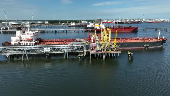 Crude Oil Tanker Ships Unloading Petrochemicals to a Shore Fuel Depot