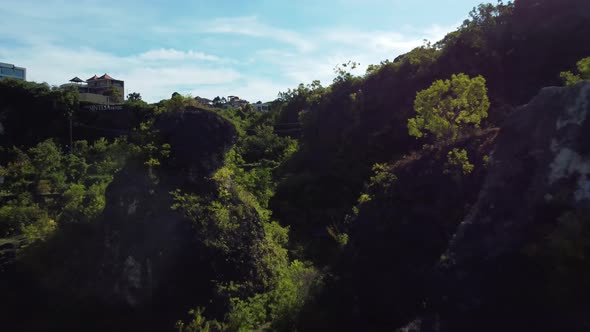 Drone Forward Flight Over the Trees Between Rocks