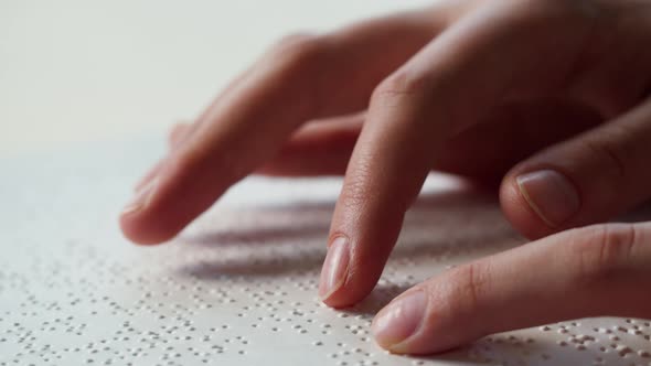 Touching Letters on Sheet of Paper Closeup Blindman Reading Braille Book Using His Fingers Poorly