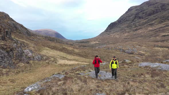 Two men hiking and exploring Highlands in Scotland - Adult men walking and en