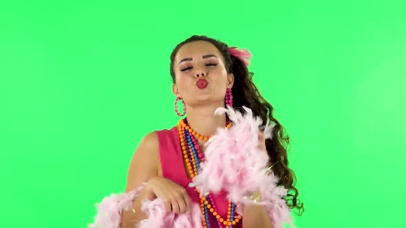 Girl Dancing, Seductively Smiling and Posing with Pink Feathers. Green Screen