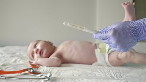 Nurse Takes a Swab From the Infant's Nose.