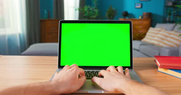 Shot of Male Hands Typing on a Keyboard Laptop with Blank Screen