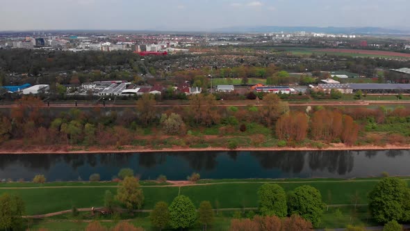 Top view of the embankment of the Neckar River. Bridges, green grass and trees. Mannheim. Germany.