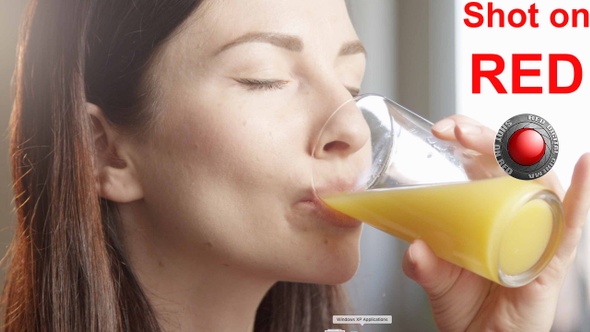 Thirsty Woman Drinking Orange Juice Indoors With Sun Shining A Close Up Shot On Red Camera