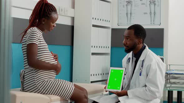 Male Physician Showing Greenscreen Template on Tablet