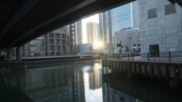 Sun reflecting off glass tower to Middle Dock Canary Wharf London