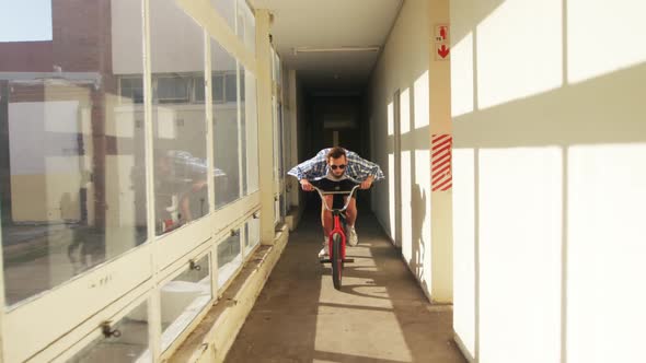 BMX rider in an empty warehouse