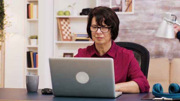 Retired Woman Working on Laptop in Living Room