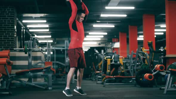 A Man Workouts with a Ball, Dropping It.