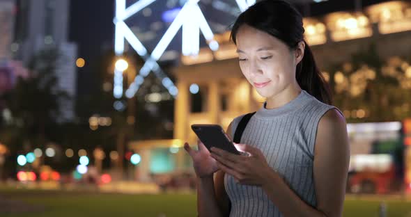 Woman using cellphone in the street at outdoor 