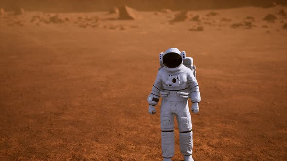 Astronaut on Mars Surface. Red Planet Covered in Gas and Rock