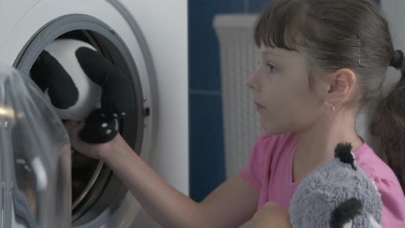 Child by washing machine. 