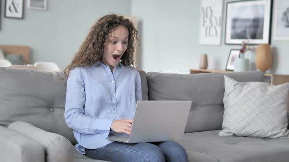 Curly Hair Woman Celebrating Success on Laptop