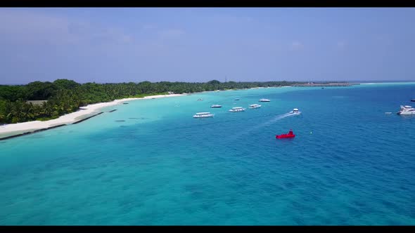 Aerial drone shot tourism of marine resort beach trip by turquoise sea and white sandy background of