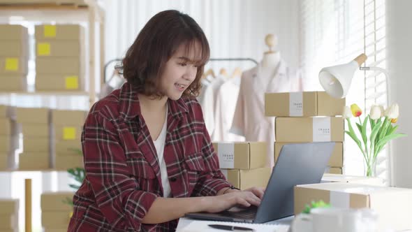 Asian small business entrepreneur ecommerce computer customer talk.