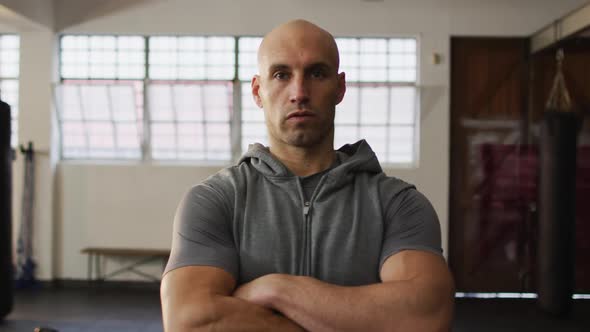 Portrait of fit caucasian man with arms crossed at the gym