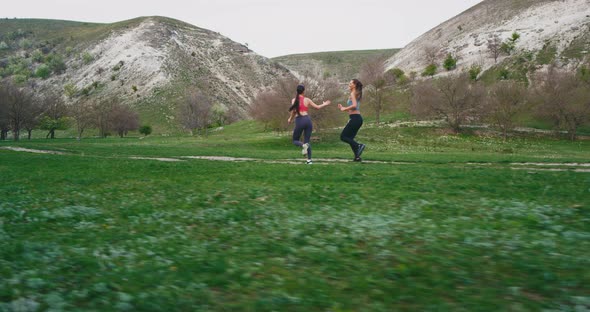 Workout at Nature Two Women Running Through a