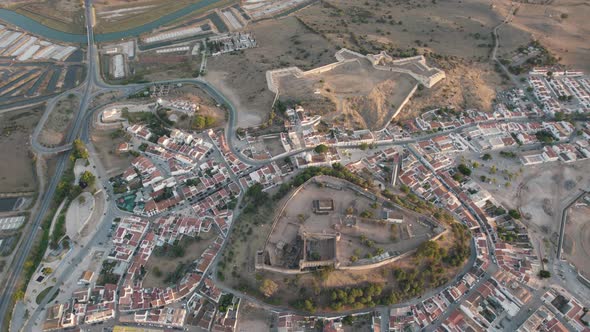 Old medieval castle on hilltop above Castro Marim town, Algarve, Portugal. Aerial rotating view