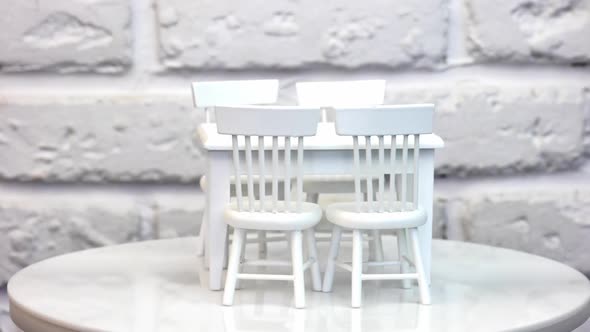 Furniture for dolls and dollhouse. Close up of toy wooden furniture, rotation