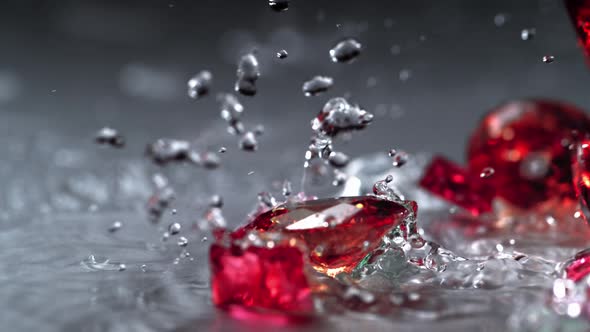 Ruby spinning on water surface. Slow Motion.