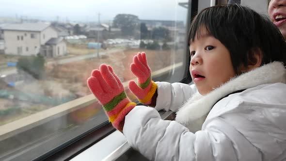 Happy Asian Child Looking Out Train Window Outside